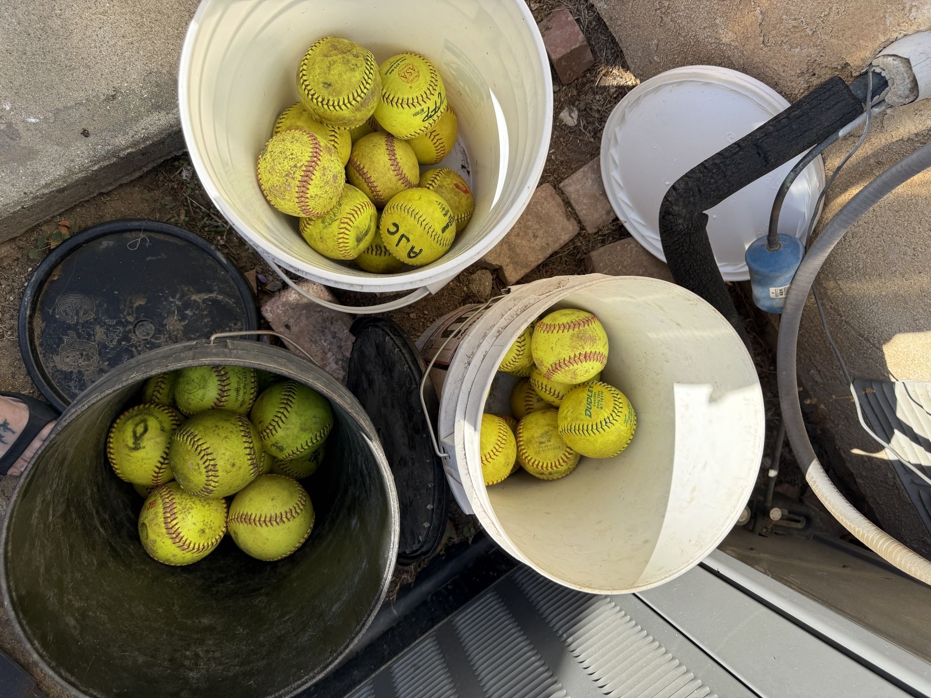 A Dozen 12 Inch Softballs And Bucket
