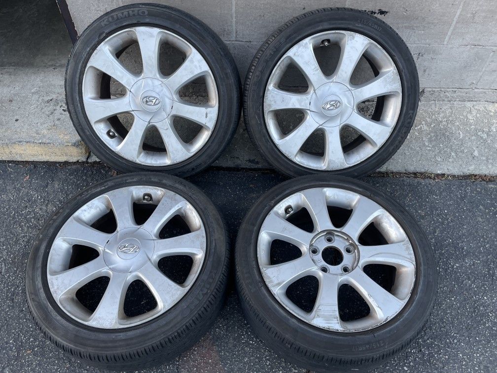 Original 17 inch aluminum Hyundai Elantra wheels with old tires