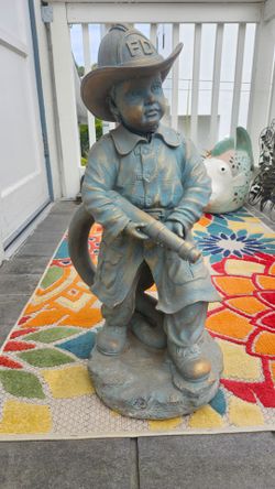 Cast statue of child as firefighter.