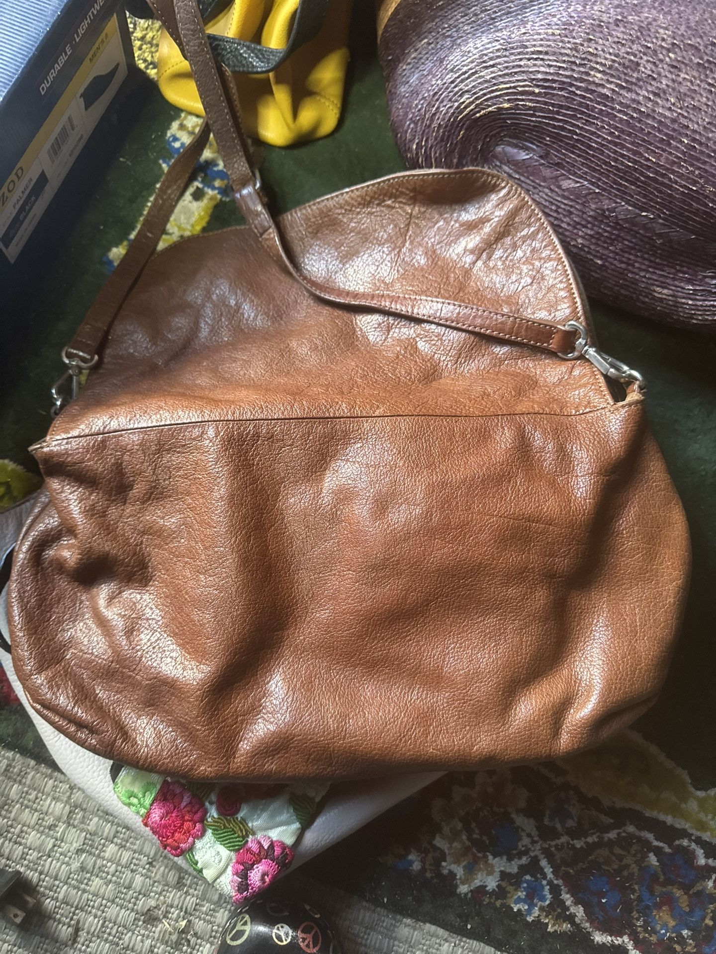brown leather hobo bag with a shoulder strap.