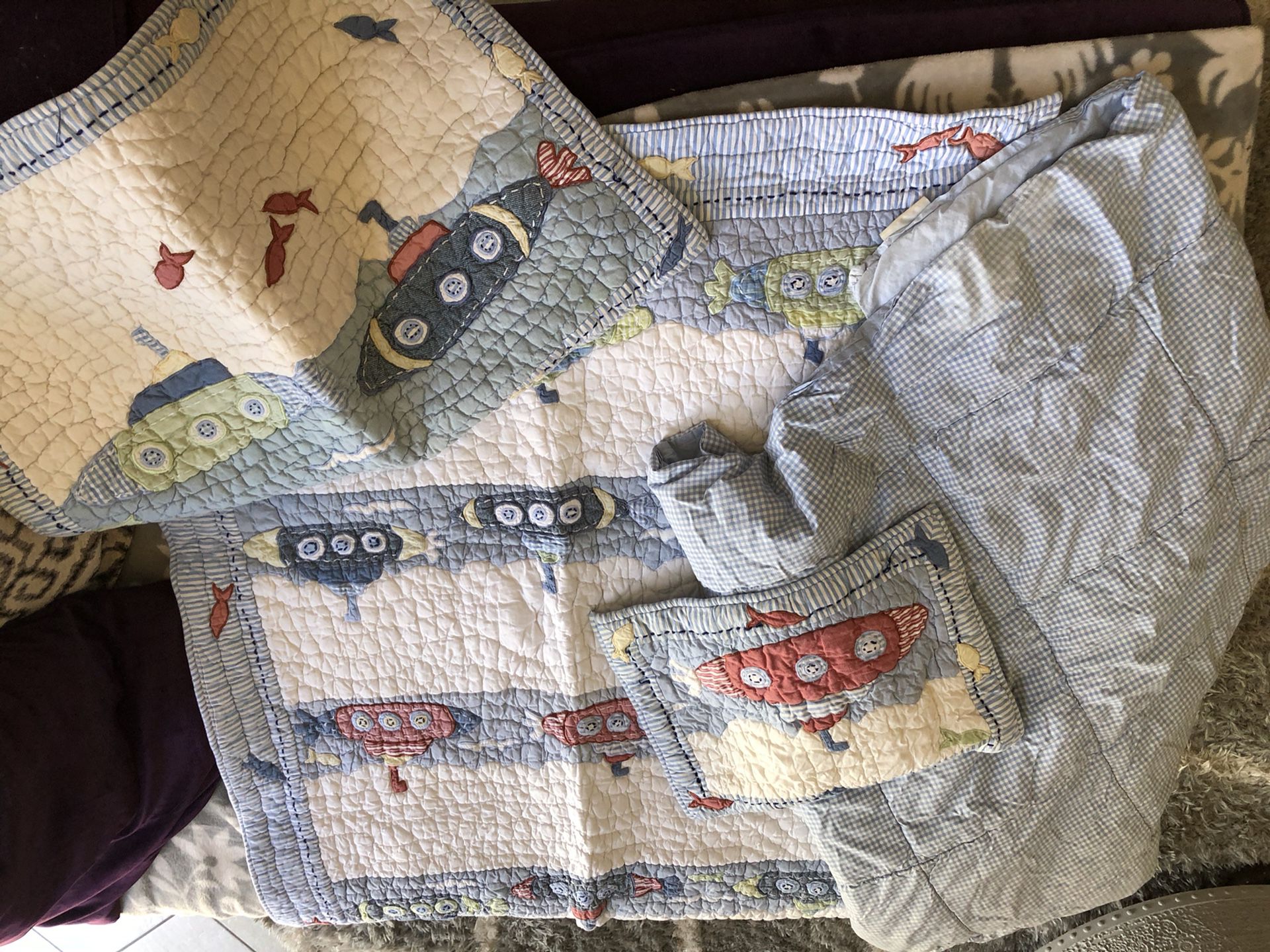 Pottery barn submarine crib set. Slight stain on gingham blanket but pillow cases and comforter are in good shape.