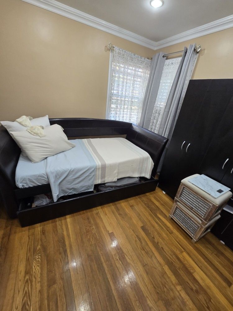 Brown leather daybed with a trundle (twin pull-out) and one mattress included.