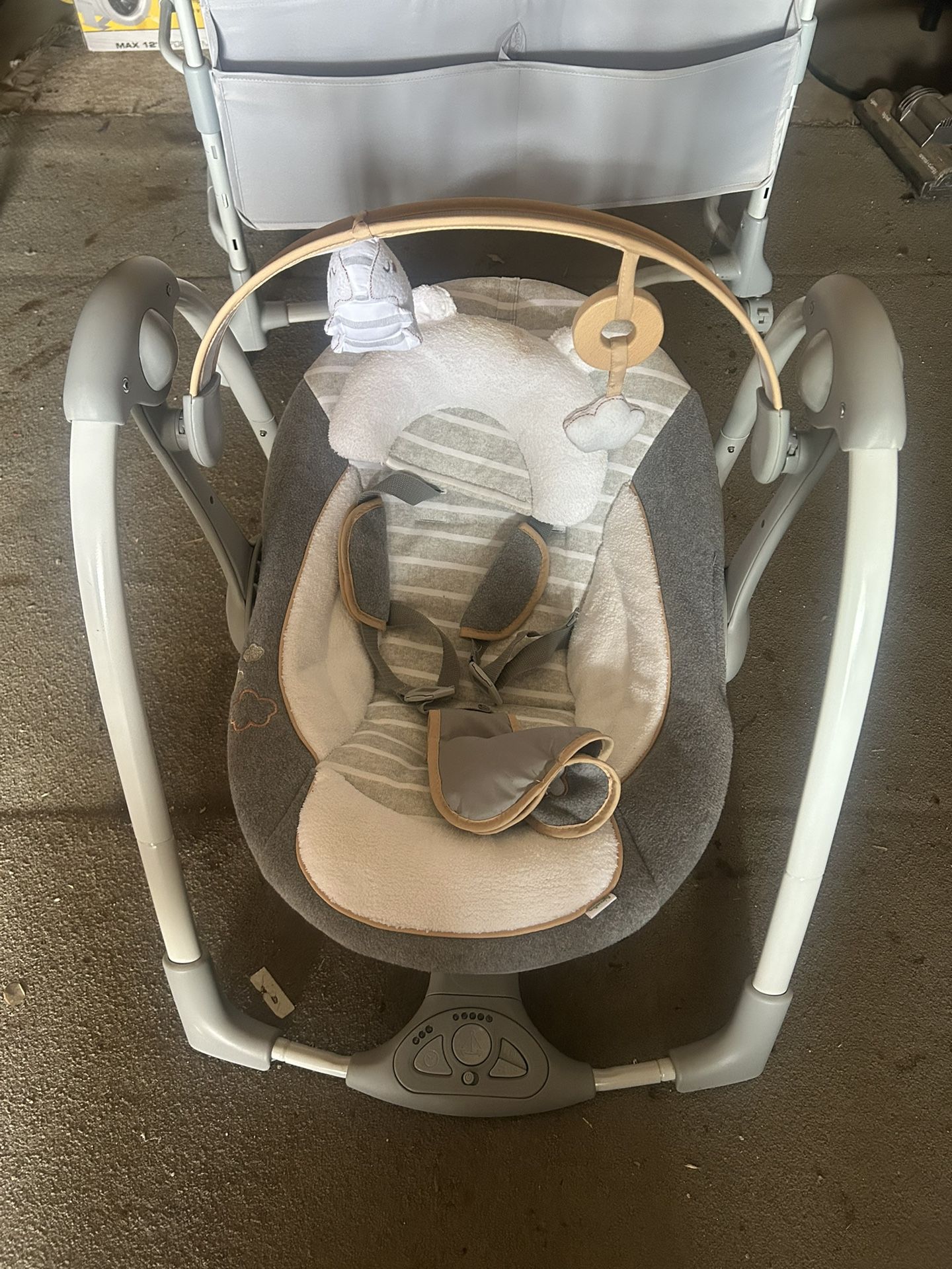 Ingenuity Dream & Grow Bedside Bassinet and an Ingenuity Boutique Collection Deluxe Swing 'n Go Portable Baby Swing in the Bella Teddy design
