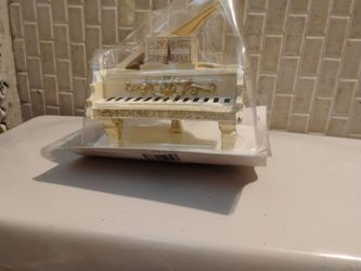 Miniature white Grand Piano with gold trim still in package.