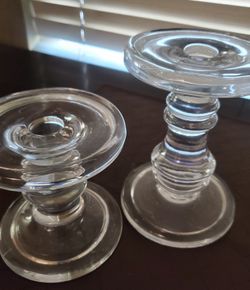 A pair of clear glass candle holders