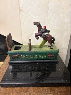 Vintage mechanical cast iron coin bank Show Jumpet