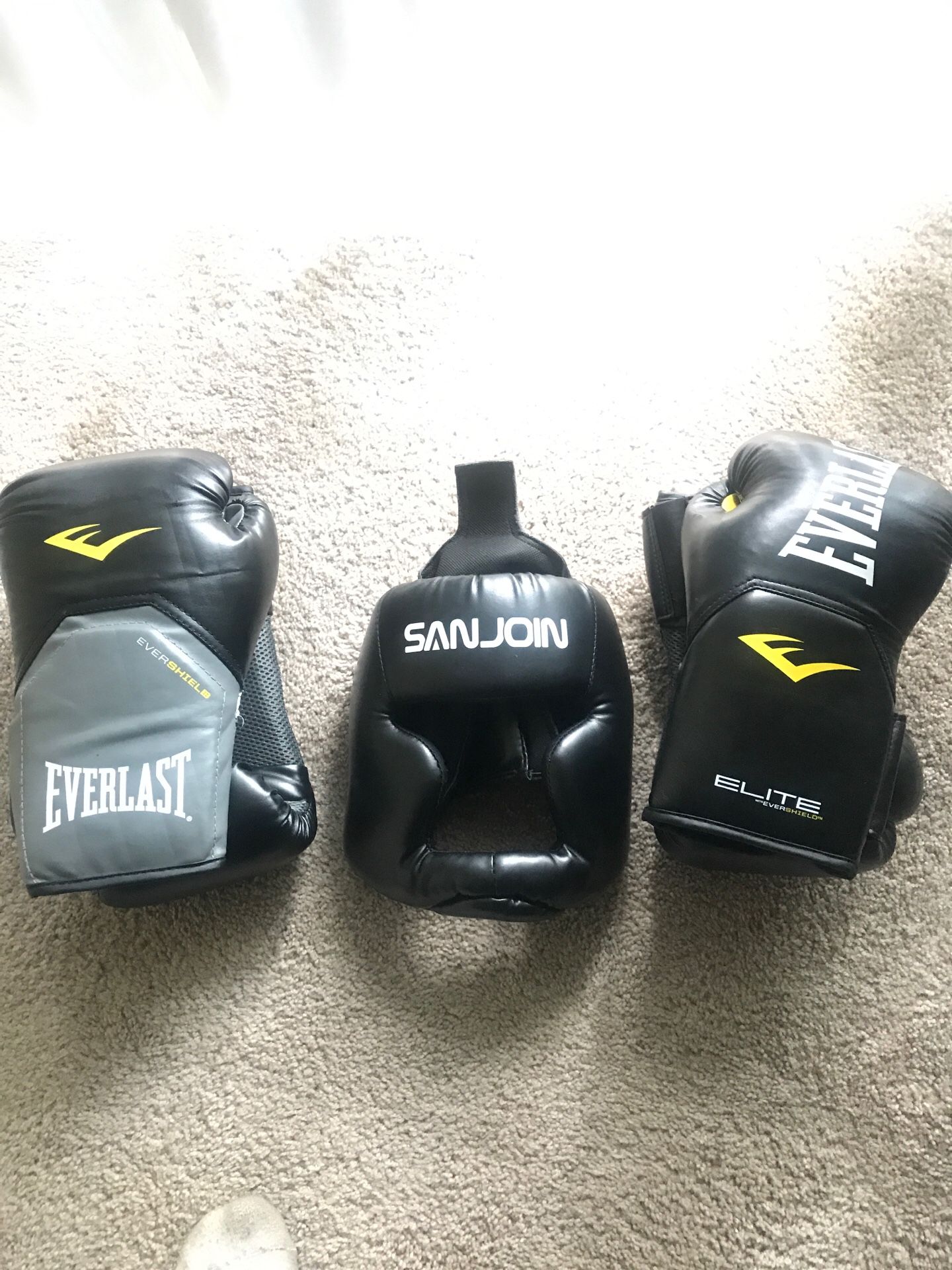 2 pair of boxing gloves and 1 head gear