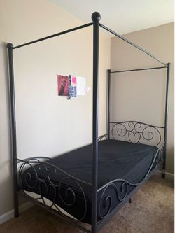 Twin metal canopy bed. Taken apart for easy transport.