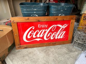 Old coca- cola sign with wooden frame