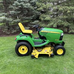 John Deere X724 All Wheel Steer Garden Tractor Lawn Mower With A 62 In Deck and 27 Liquid Cooled Kawasaki 