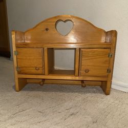 Heart cut out wooden wall cabinet with shelf and pegs