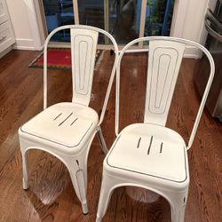 Two metal white chairs