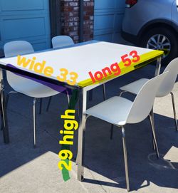 White Ikea table with 4 chairs