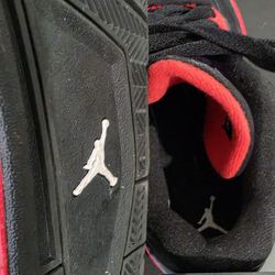 Used like new.  Nike Air Jordan 4 Retro sneakers in the "Red Thunder" colorway.