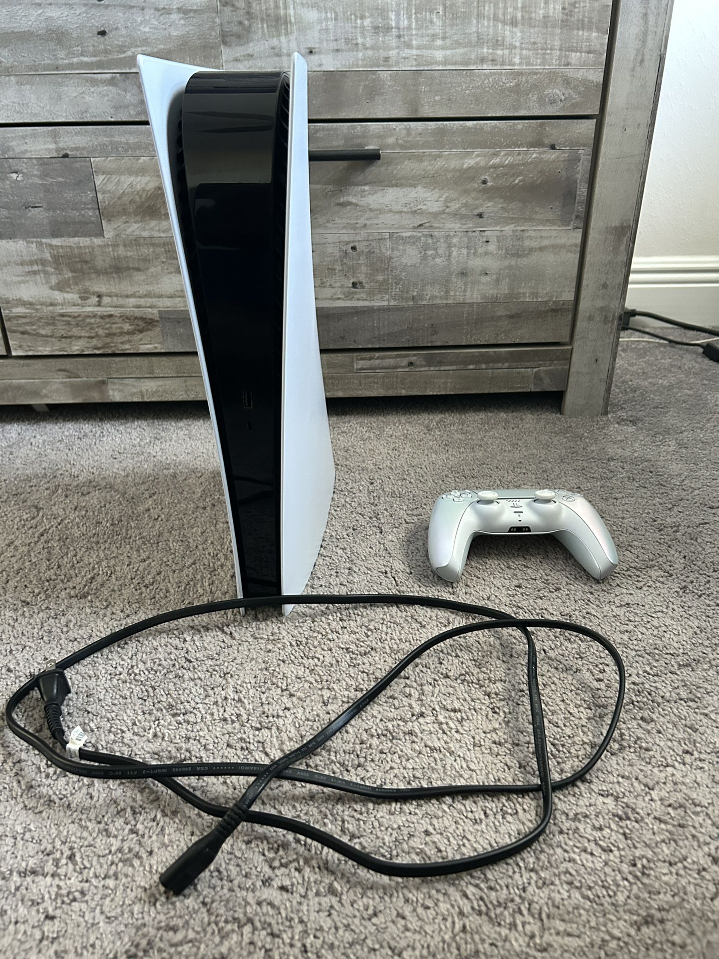 Sony PlayStation 5 Console Digital Edition and DualSense controller.