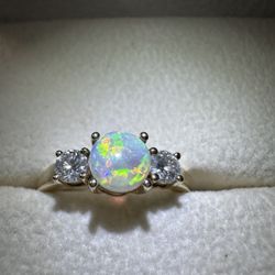 Elegant and timeless Angara Classic Opal and Diamond Three-Stone Engagement Ring in 14K yellow gold.
