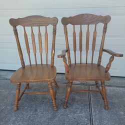 2 Vintage Wood Dinning room chairs. Solid wood 1 has the arm rest 