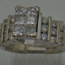 14KT WHITE GOLD ENGAGEMENT RING SIZE 5.75; 8.8 GRAMS; 27 DIAMONDS (  9 PRINCESS CUT, 18 ROUND ) TOTAL 1.25 CARAT . MINT CONDITION. 857498-1.  