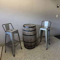 Wine barrel table with rustic metal stools