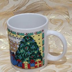 Festive mug for holiday drinks. Has sweet Christmas scenes all around. One side has a Christmas tree with presents and a snowy window. Other side has 