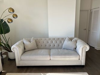 Light gray tufted sofa