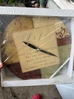 Round decorative wall clock featuring an inspirational quote about life & dancing in the rain