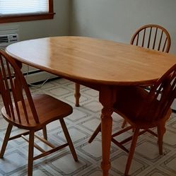 Farmhouse kitchen table with 3 chairs.