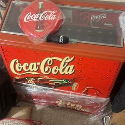 Coca Cola fridge, Model number RPUC100 and Deadstock 2010 Coca-Cola Hallow Curved Tin Button Sign 