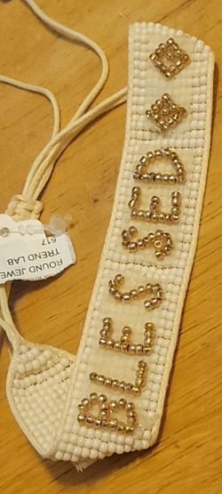 An adjustable, hand-woven "BLESSED" seed bead bracelet