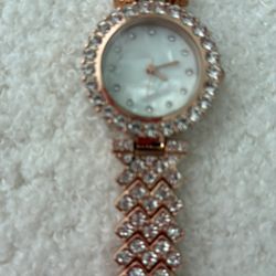 Reduce price. Rose gold watch with rhinestone band.
