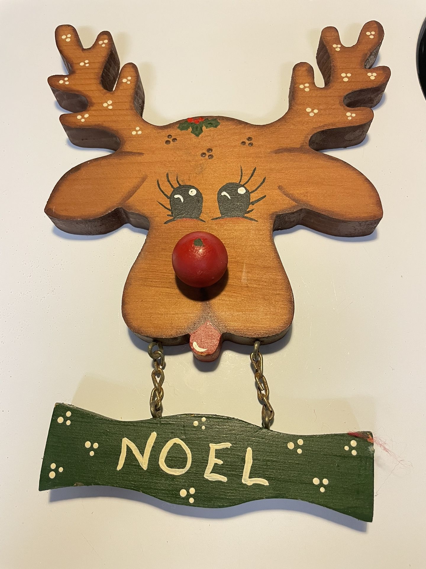 This is a hand-painted wooden reindeer door hanger, a type of holiday decoration or collectible. It