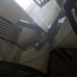 Round glass dining room table with 4 chairs