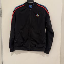 Worn once.Sleek black bomber jacket with vibrant red and blue shoulder stripes. Features iconic Adidas logo. Perfect for casual wear.
