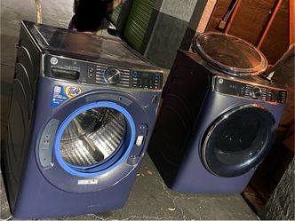 Set of dark blue GE profile front-load laundry appliances ( washing machine and matching dryer in sapphire blue)