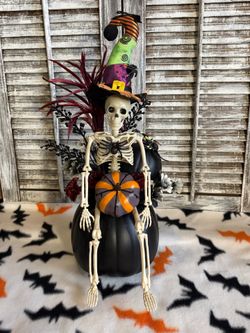Ht-17in HANDMADE artificial skeleton arrangement on a black pumpkin