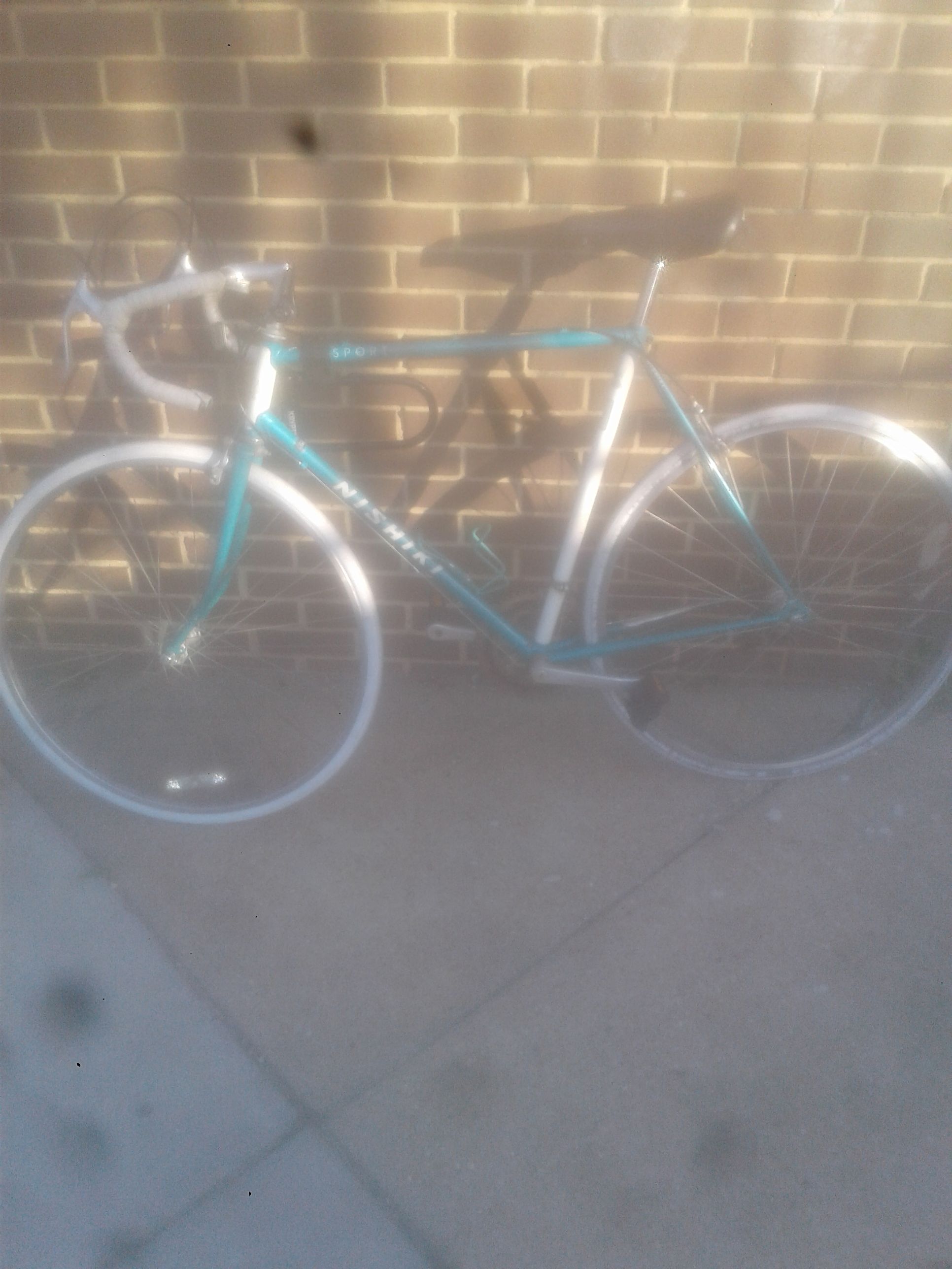 Nishiki sport racing bike, color is aqua blue and white with white tires. Champion handle bars with white wrap.