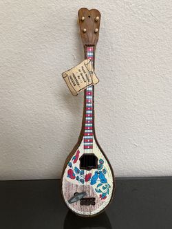 vintage music “instrument” wood sculpture imitating Greek mandolin, playing a classic tune