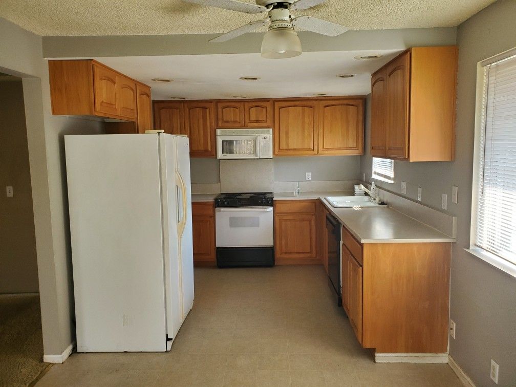 Kitchen cabinets, stove, microwave