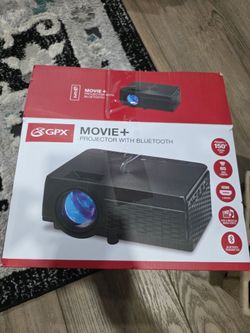 Small mini black projector home or office use play movie's play games.