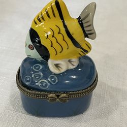 Modern ceramic trinket box featuring a yellow fish figurine.
