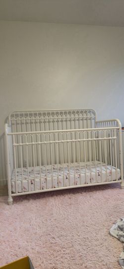 Crib and pink rug