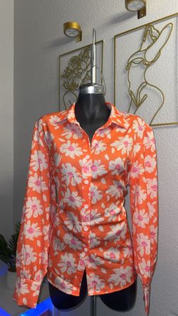 Orange Blouse With A White  Floral Pattern