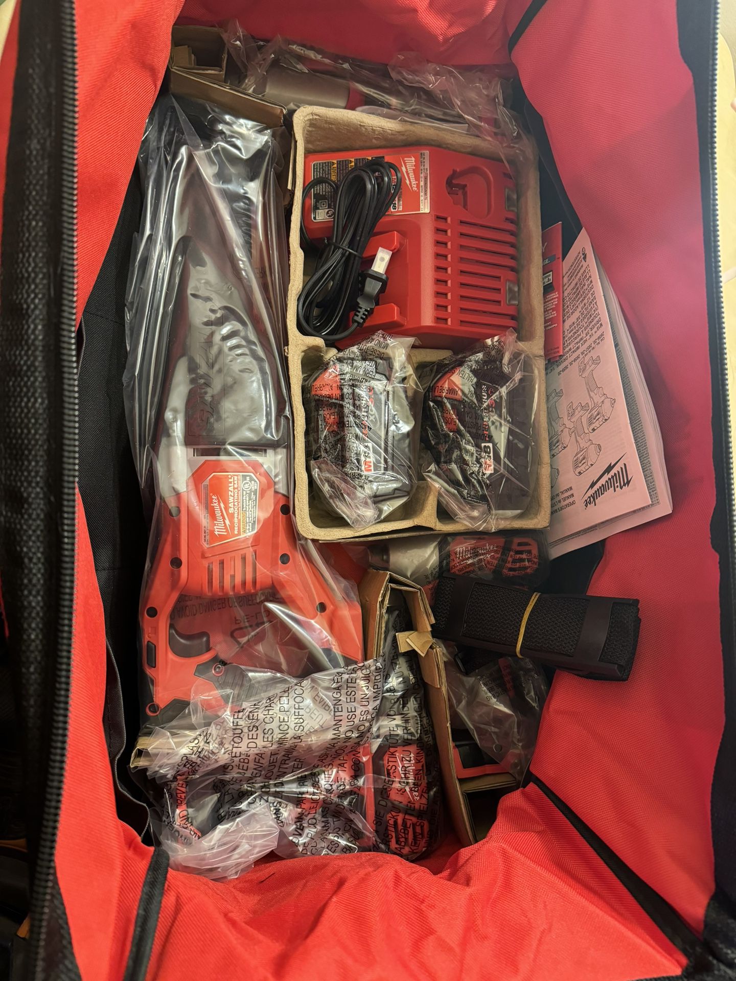 Milwaukee M18 Cordless Combo Set (4 Tools) with Two 3 Hr Batteries, Charger, and Tool Bag.  Tools Include: Hammer Driver Drill, Impact Driver, Sawzall