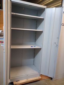 Solid metal storage cabinet with keys adjustable shelves