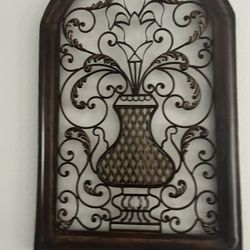 “Traditional Tuscan-inspired metal wall art with ornate scroll patterns.