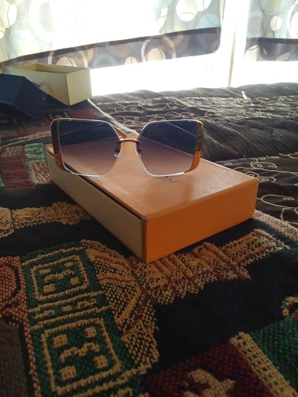 Elegant Louis Vuitton Sunglasses With Gold Trim