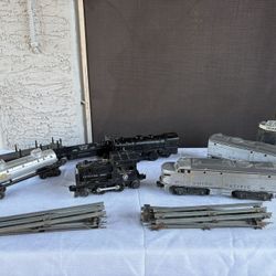 vintage Lionel postwar O gauge model trains and track, featuring a Union Pacific Diesel set (number 2023) and a United States Army locomotive. 