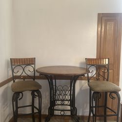 Bar table with storage for wine and glasses with two chairs