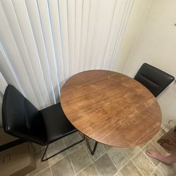 Foldable Wooden Kitchen Or Coffee Table And Black Cushioned Chairs 