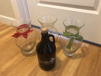 three vases and a bottle with a cork